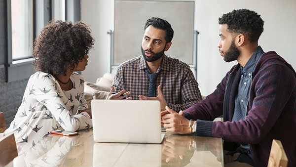 Two men and a woman in a meeting